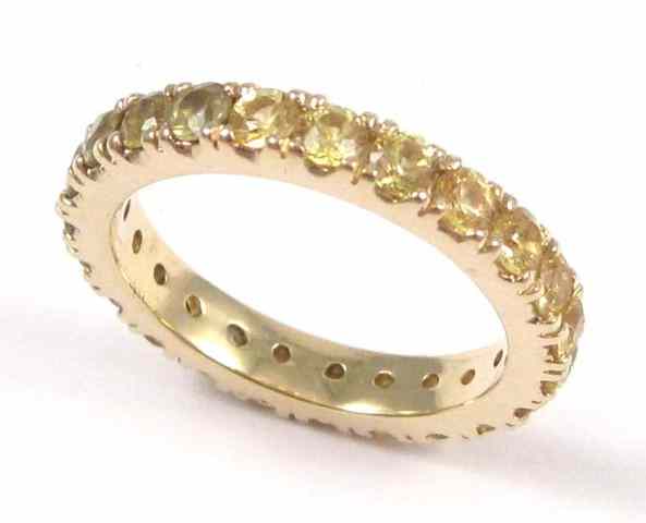 Appraisal: YELLOW SAPPHIRE ETERNITY RING k yellow gold set with a