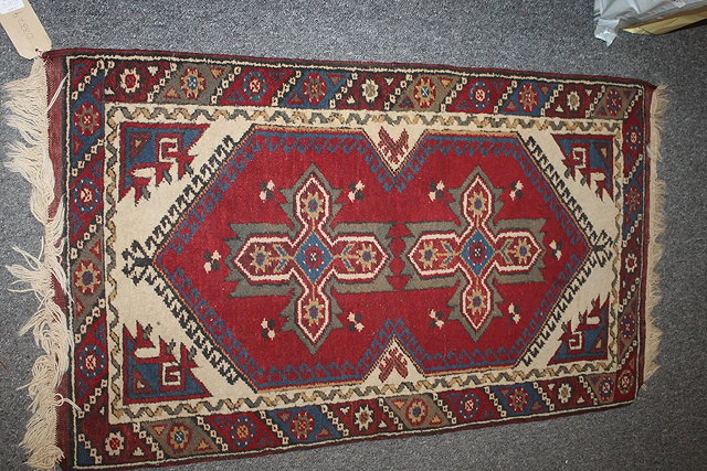 Appraisal: AN EASTERN WOOL RUNNER with red ground running borders and