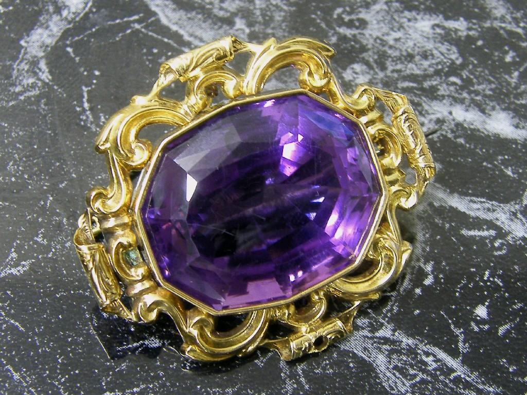 Appraisal: Antique amethyst brooch oval facet cut in a yellow gold