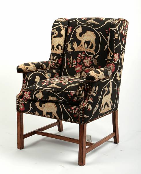 Appraisal: A George III style mahogany and fully upholstered wing armchair