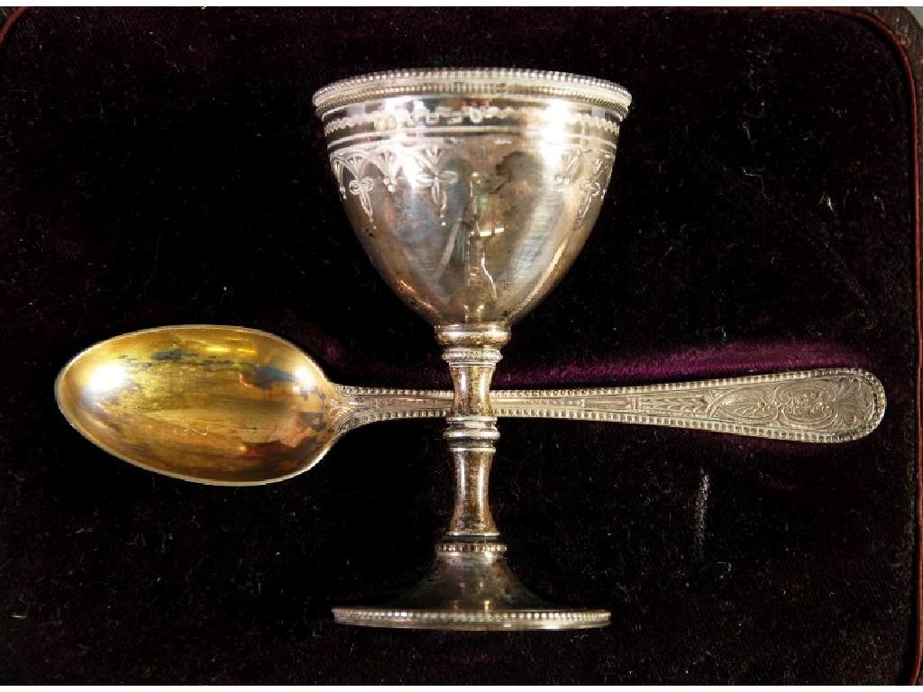 Appraisal: VICTORIAN SILVER EGG CUP AND SPOON bright cut engraved and