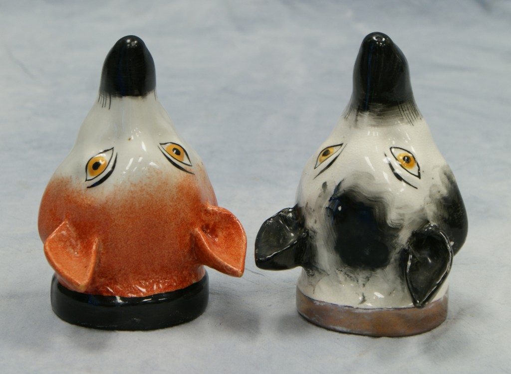 Appraisal: Staffordshire fox head stirrup cups rust black decoration tallest