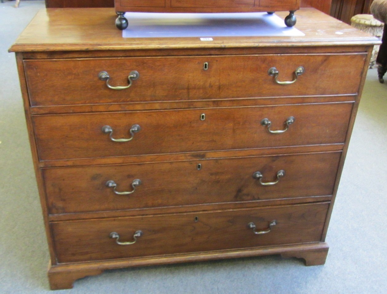 Appraisal: An th century oak chest of four long graduated drawers