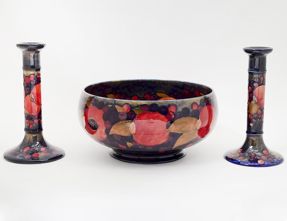 Appraisal: MOORCROFT BOWL AND CANDLSTICKS Signed In the pomegranate pattern Diameter