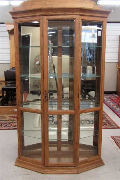 Appraisal: MODERN OAK AND BEVELED GLASS DISPLAY CABINET having a canted