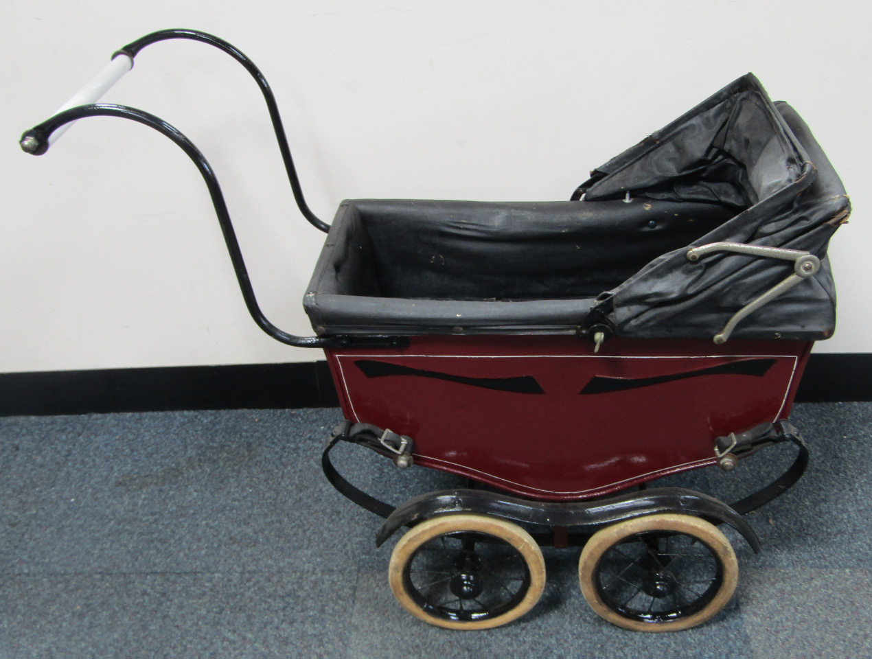 Appraisal: A Leeway baby carriage in red on a black chassis