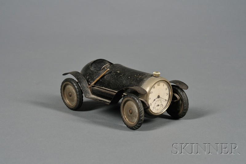 Appraisal: Black-painted Tin and Steel Roadster Race Car Clock America th