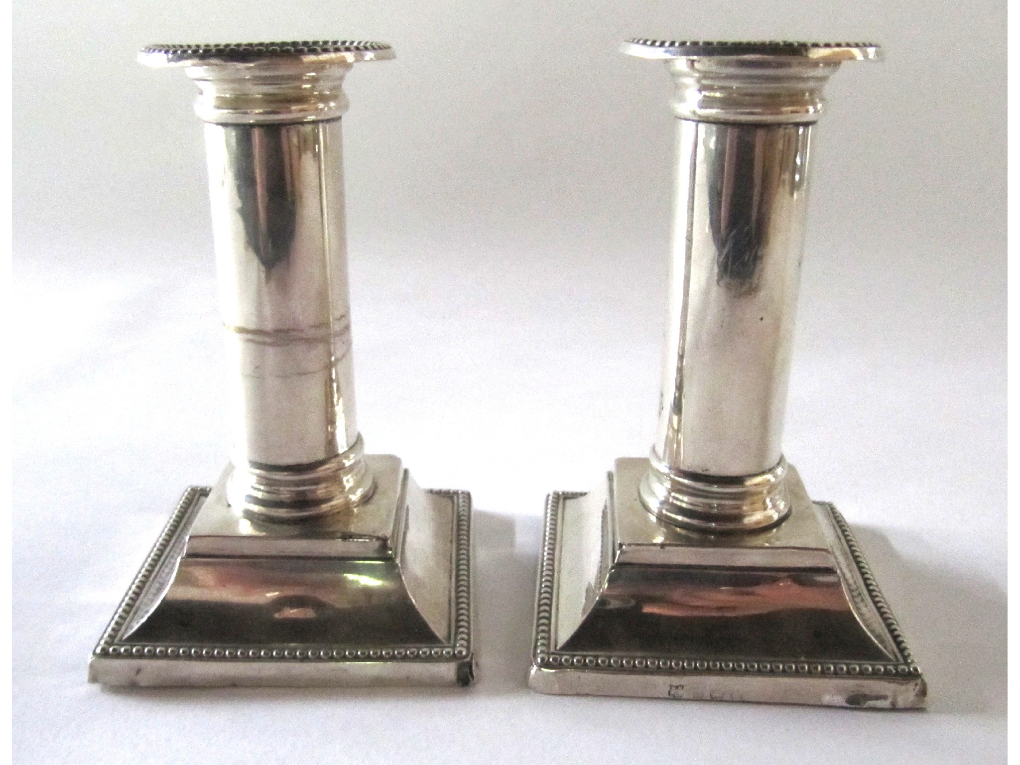 Appraisal: A pair of silver candlesticks Birmingham