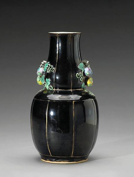 Appraisal: A mirror black and polychrome enameled porcelain vase of gourd