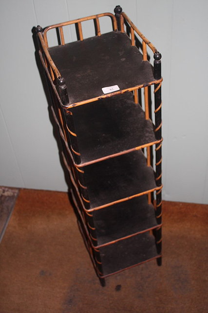 Appraisal: A NARROW EBONISED AND CANE FOUR TIER WHATNOT cm high