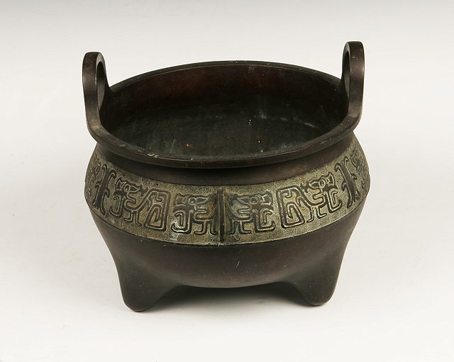 Appraisal: A CHINESE BRONZE TWO HANDLED BOWL with stylised character decoration