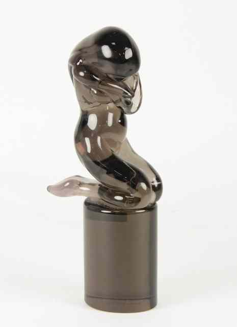 Appraisal: A Murano glass figure of a kneeling woman on an