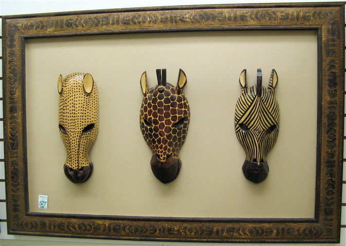 Appraisal: FOUR AFRICAN HAND CARVED AND PAINTED WOODEN MASKS PLAQUES mounted