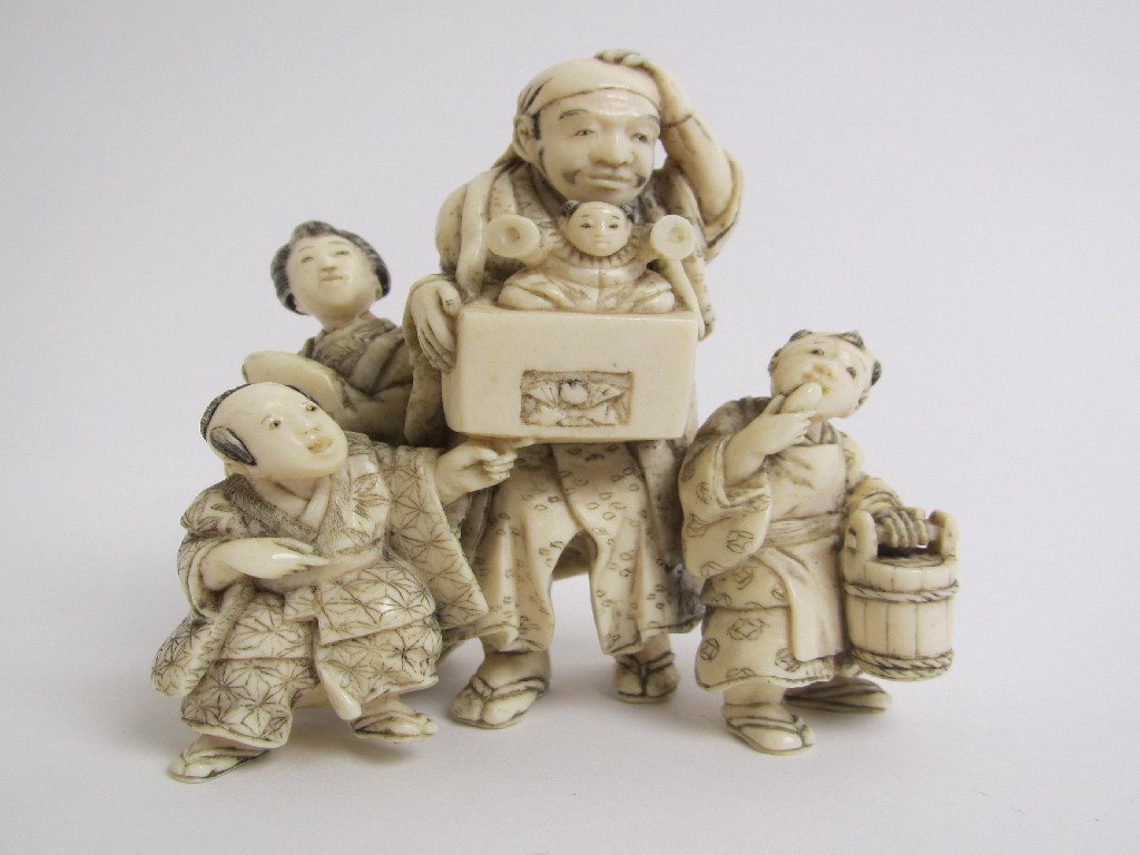 Appraisal: A Japanese ivory okimono family group with mother father and