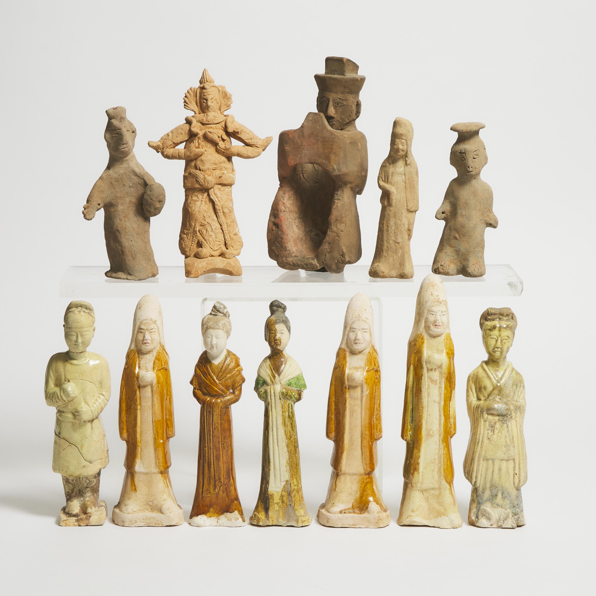 Appraisal: A Group of Twelve Pottery Figures Han-Tang Dynasty BC-AD Consisting