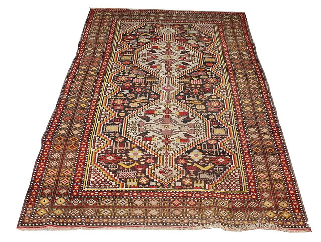 Appraisal: AN UNUSUAL PERSIAN RUG with an inter-connecting medallion within a