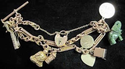 Appraisal: Yellow gold charm bracelet Featuring various gold and gold tone