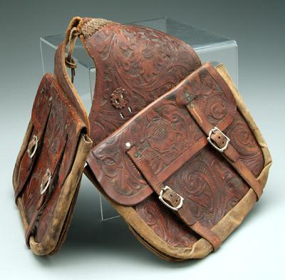 Appraisal: Tooled leather saddlebags elaborate flower and vine decoration buckled strap