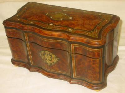 Appraisal: A FRENCH AMBOYNA AND EBONY CADDY of serpentine oblong form