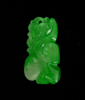 Appraisal: A Carved Bright Green and White Jadeite Ornament Chinese Translucent