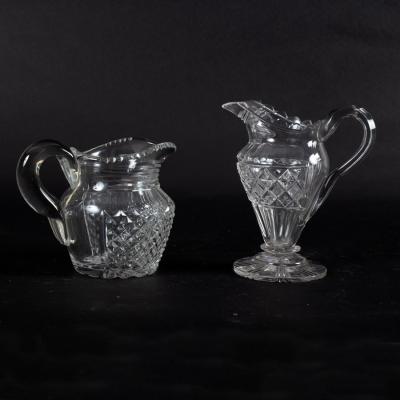 Appraisal: A Georgian cut glass pedestal jug with strawberry cut decoration