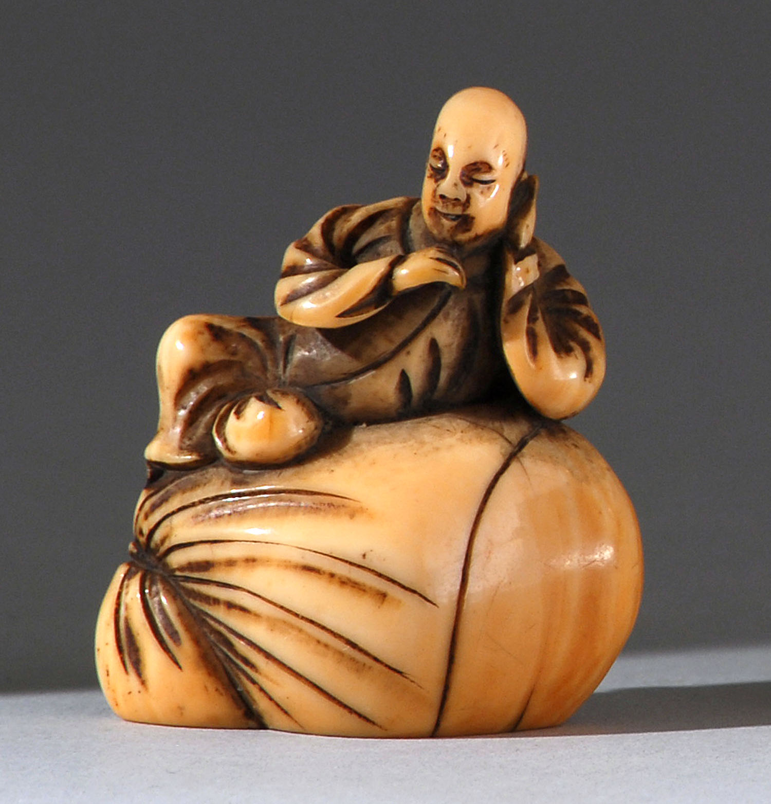 Appraisal: IVORY NETSUKE th CenturyIn the form of a child resting