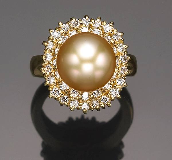 Appraisal: A cultured pearl and diamond ring the golden cultured pearl