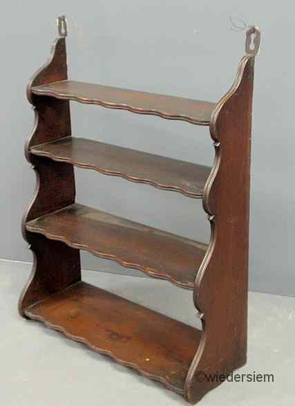 Appraisal: Mahogany hanging shelf with scalloped sides and shelves ''h x