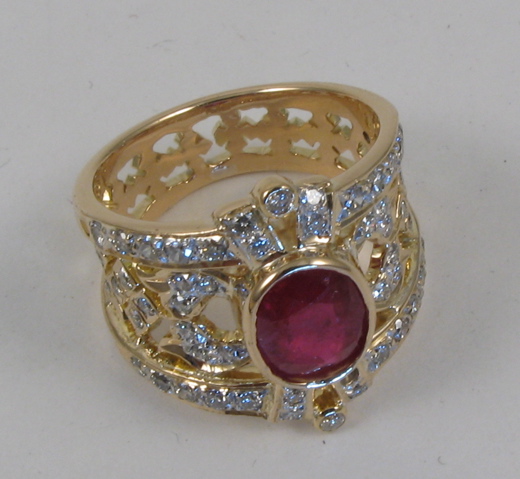 Appraisal: RUBY DIAMOND AND FOURTEEN KARAT GOLD RING centering an oval-cut