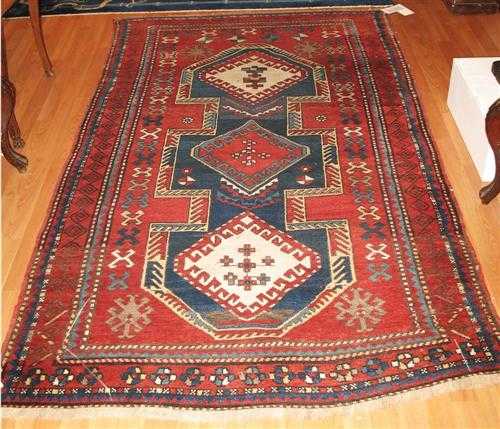 Appraisal: KAZAK old Red ground with a blue central medallion geometrically