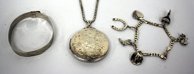 Appraisal: A CIRCULAR SILVER LOCKET with etched floral decoration a silver