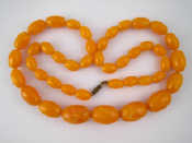 Appraisal: A graduated amber bead necklace largest bead approx mm long