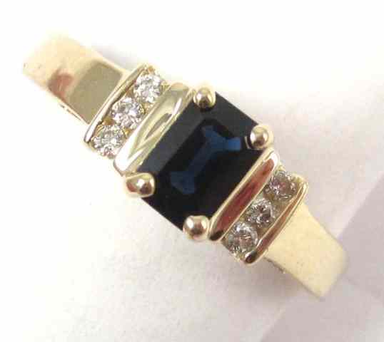 Appraisal: SAPPHIRE DIAMOND AND FOURTEEN KARAT GOLD RING featuring an emerald-cut