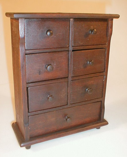 Appraisal: A small antique mahogany stained nest of seven drawers