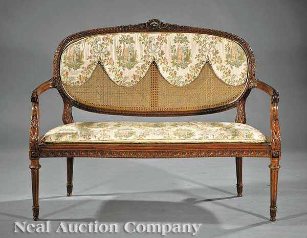 Appraisal: A Louis XVI-Style Carved Fruitwood and Caned Canap guilloche and