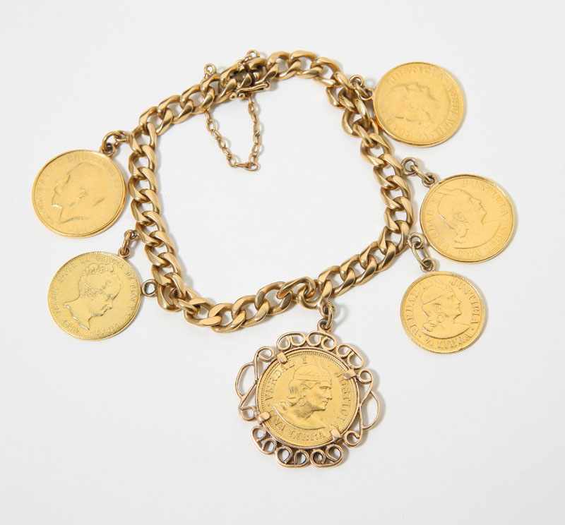 Appraisal: K yellow gold charm bracelet suspending gold coins mostly Peruvian