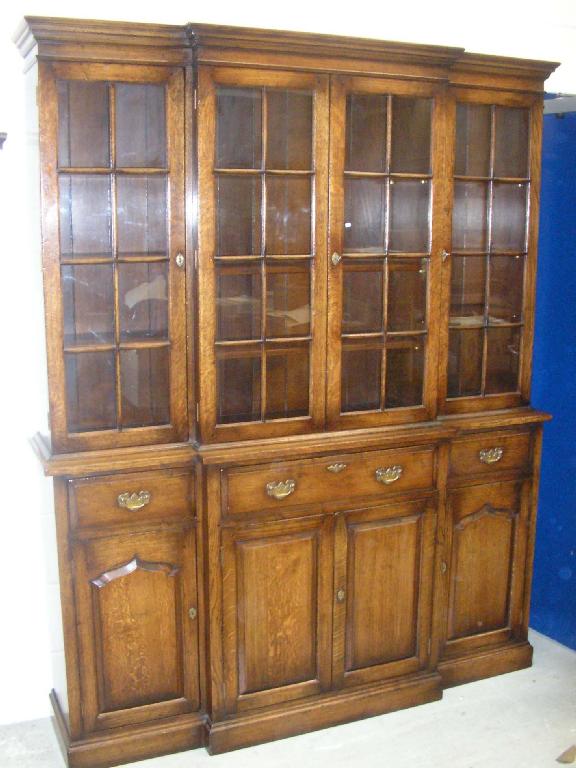 Appraisal: A reproduction oak breakfront glazed bookcase -