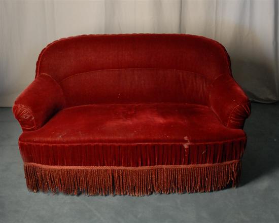 Appraisal: Art Deco Settee upholstered in red mohair fabric fringe skirt