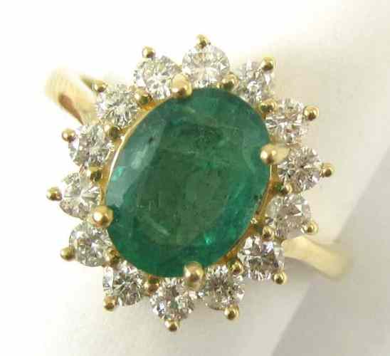 Appraisal: EMERALD DIAMOND AND FOURTEEN KARAT GOLD RING round-cut diamonds surround