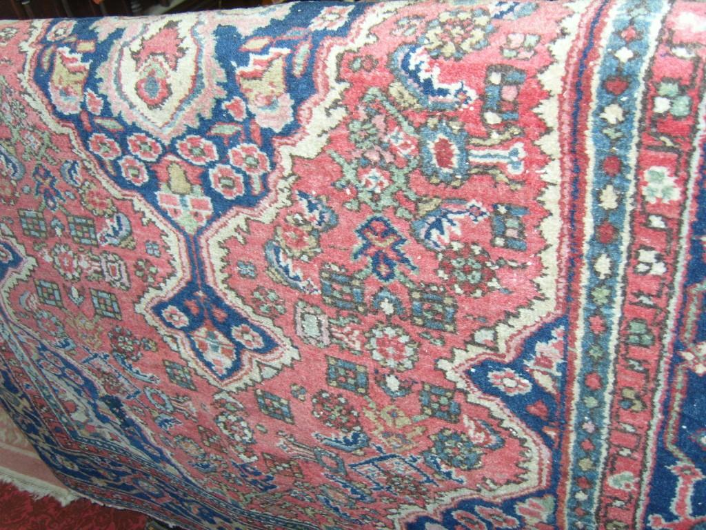 Appraisal: A red ground eastern wool rug with stylised floral decoration