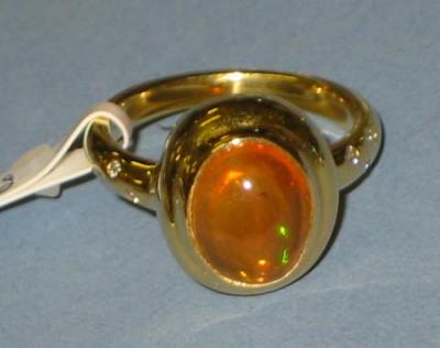 Appraisal: A FIRE OPAL AND DIAMOND RING the oval cabochon opal