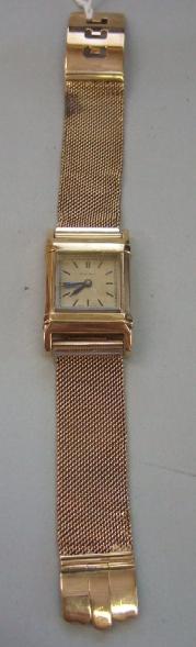 Appraisal: A gentleman's gold rectangular cased wristwatch the glazed slide off