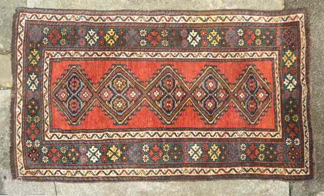 Appraisal: A HAMADAN RED GROUND RUG with central panel within a