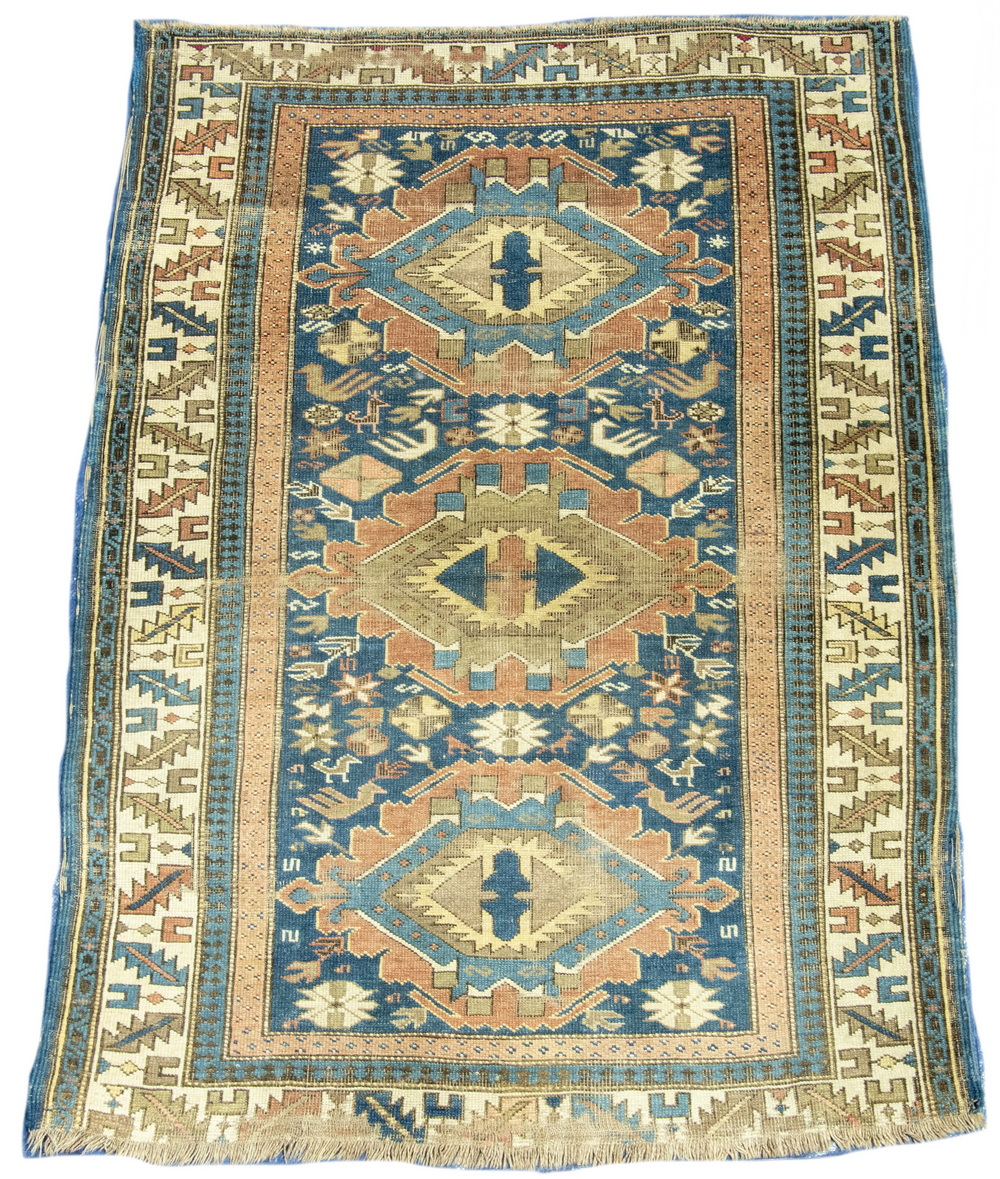 Appraisal: KAZAK RUG Three notched diamond motifs in terra cotta gold