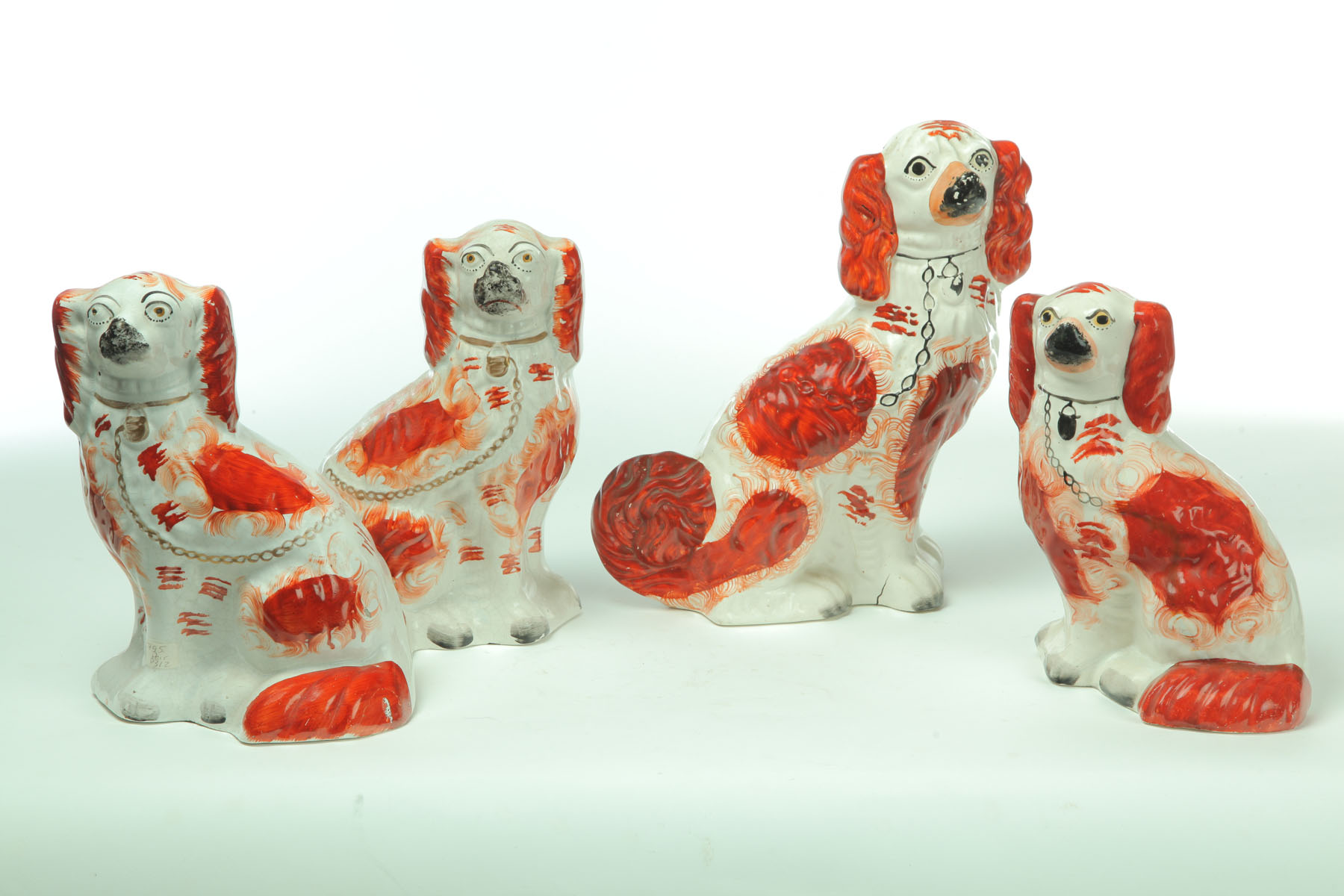 Appraisal: FOUR STAFFORDSHIRE DOGS England nd half- th century Spaniels with