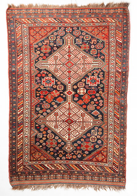 Appraisal: A QASHQAI BLUE GROUND RUG with interlinked double central medallion