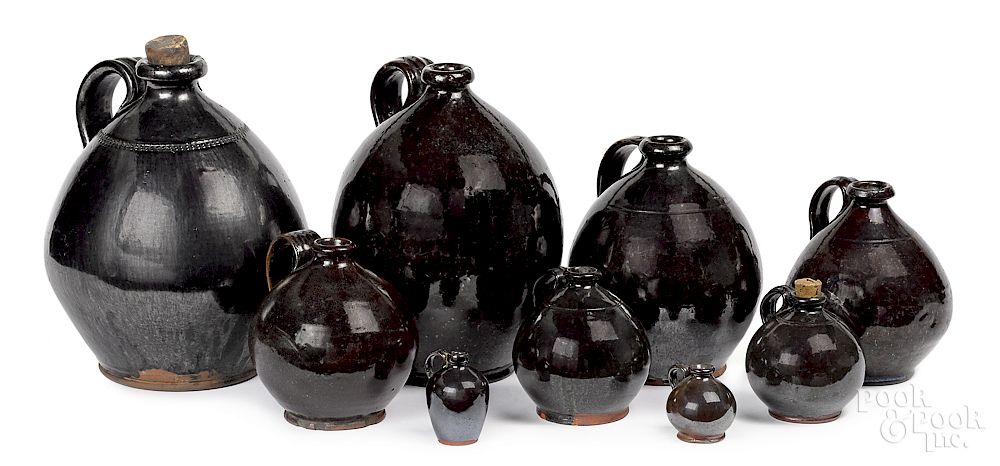 Appraisal: Nine graduated redware manganese glaze ovoid jugs Nine graduated redware