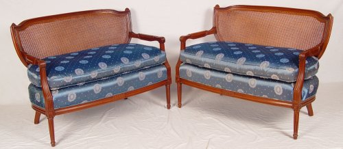 Appraisal: PAIR OF FRENCH STYLE CANED BACK SETTEES Shield back design