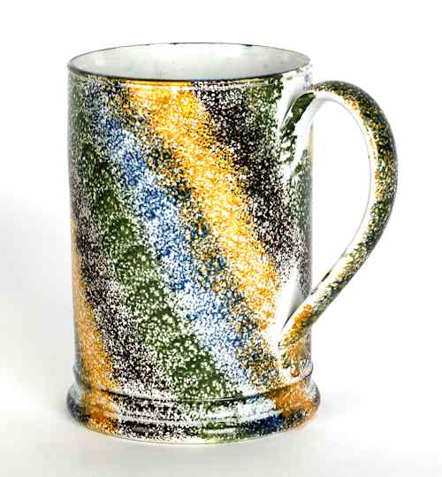 Appraisal: Yellow blue orange brown and green rainbow spatter mug th