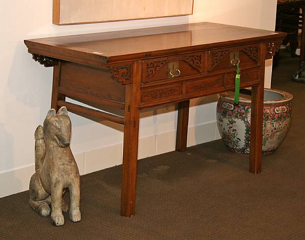 Appraisal: A Chinese style wood table With two drawers fronted with